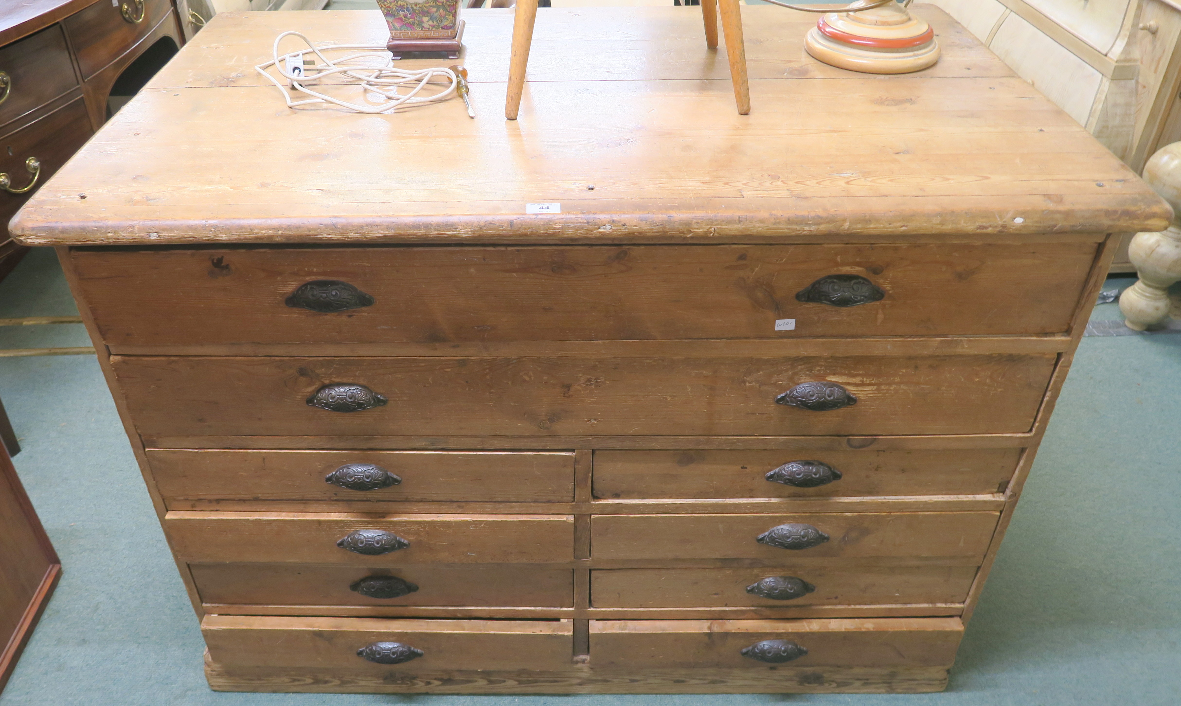 A pine plan chest with two full width drawers over eight drawers and cast iron pull handles, 94cm