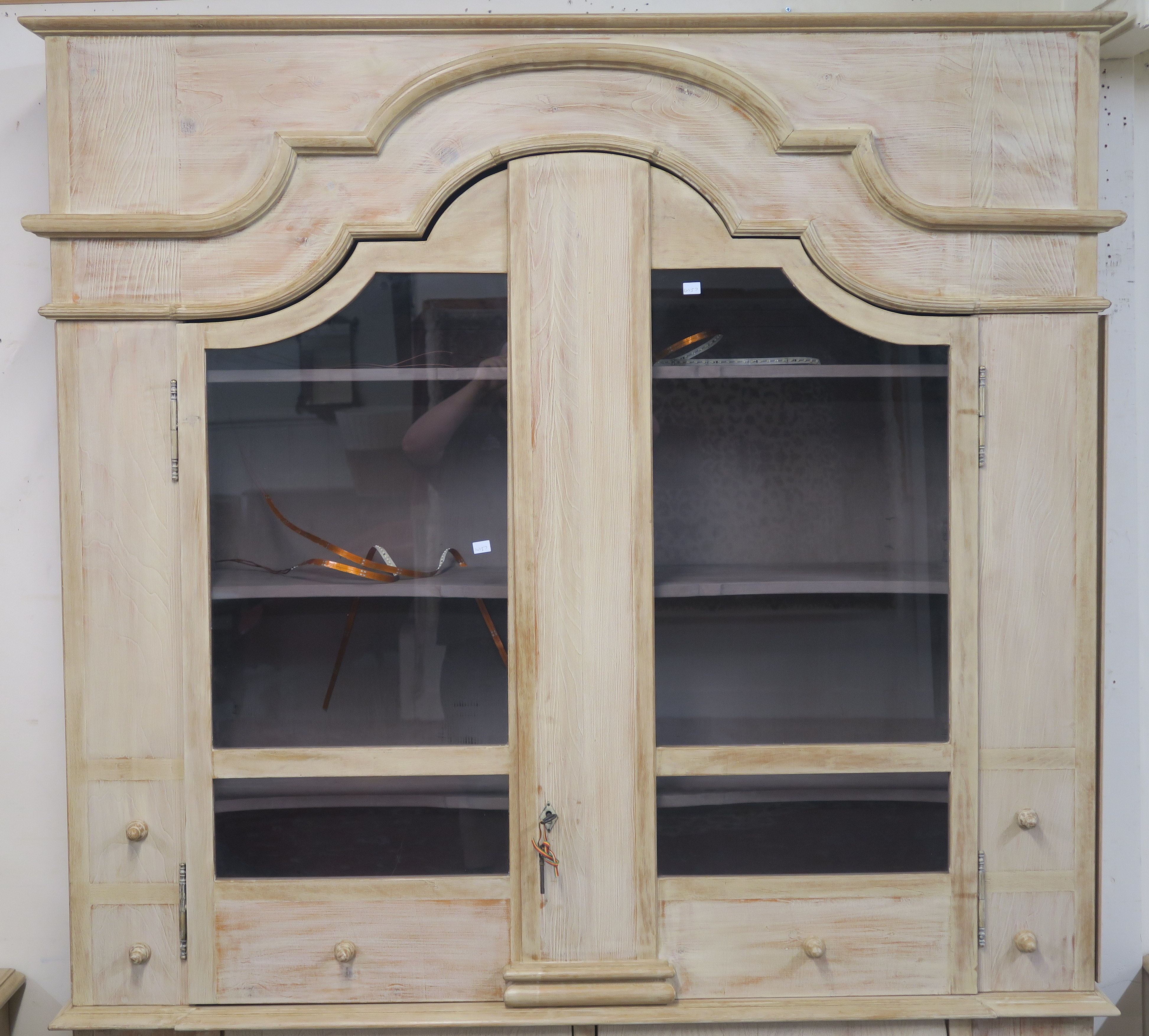 A modern limed pine display cabinet with shaped crown with two shaped glazed doors with shelves - Image 2 of 6