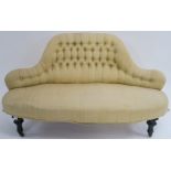 A Victorian button back sofa with shaped back on ebonised legs with ceramic castors, 75cm high x