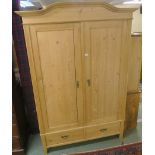 A pine armoire with two doors over two drawers, 210cm high x 144cm wide x 63cm deep Condition