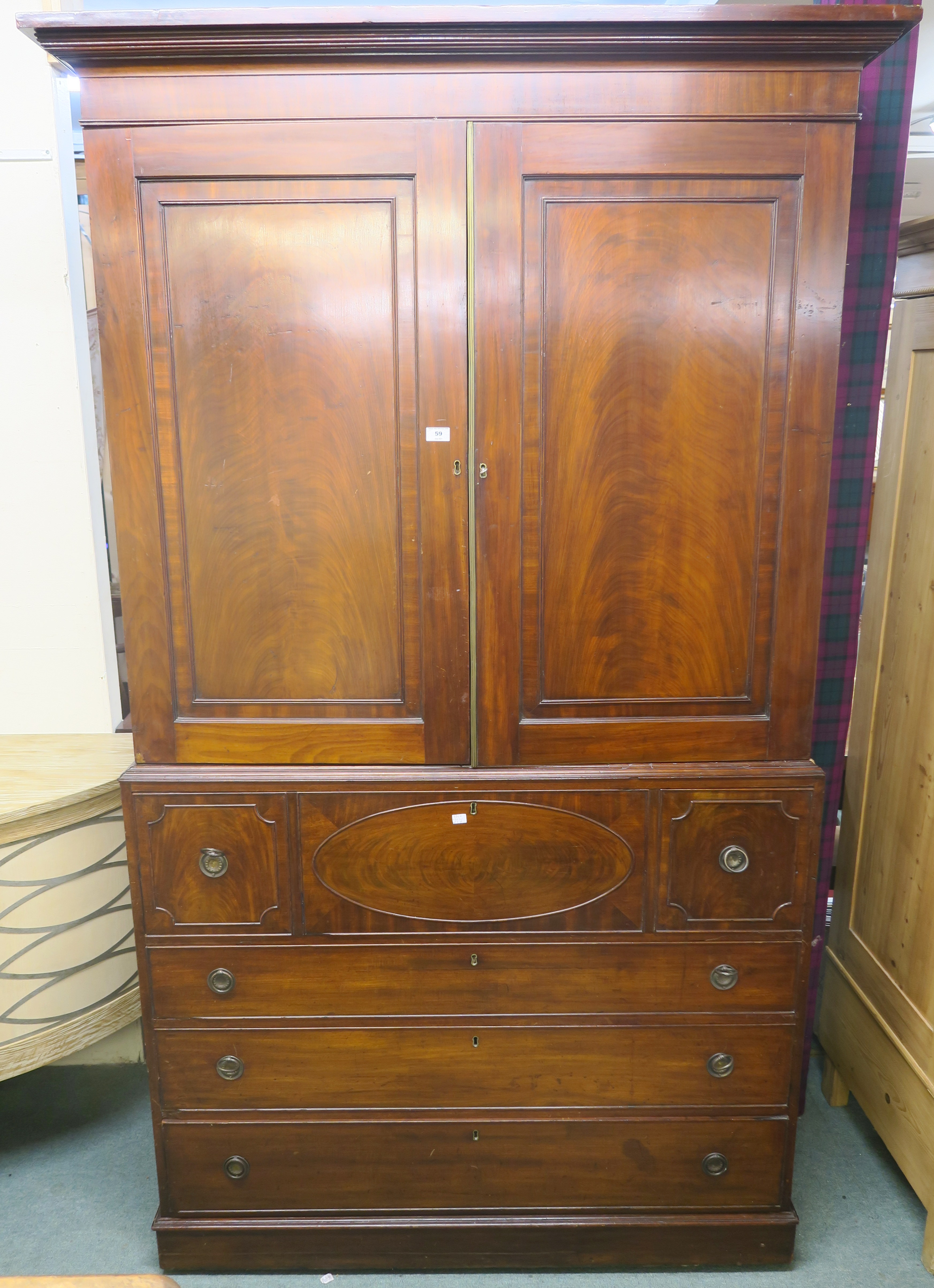 A Victorian mahogany linen press with two doors over four drawers, 226cm high x 130cm wide x 62cm