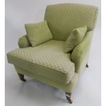 A green upholstered armchair on square tapering legs with brass castors, 84cm high Condition Report: