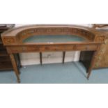 A reproduction concave writing desk with multiple small drawers, brass gallery with green skiver