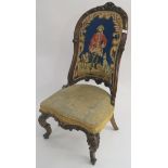 A Victorian walnut carved chair with a woolwork back of gentleman and hounds Condition Report:
