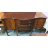 A reproduction serpentine front sideboard with three drawers flanked by two doors, 92cm high x 152cm