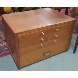 A teak and pine collectors cabinet with four drawers and brass campaign style brass side handles,