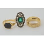 A 9ct gold wedding ring size O1/2, a bloodstone signet ring in yellow metal size O1/2, and a gem set