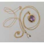 A 9ct gold amethyst set pendant and chain length 50cm, and a sapphire set wishbone pendant and chain