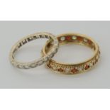 A 9ct white gold clear gem set eternity ring size Q1/2, together with a yellow metal example set