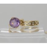 A 9ct gold Celtic knotwork wedding ring size M1/2, together with a 9ct amethyst set ring, size H,