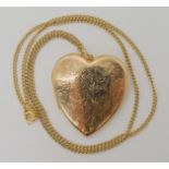 A large 9ct gold heart shaped locket dimensions including bail 4.5cm x 3.8cm, with a 9ct gold