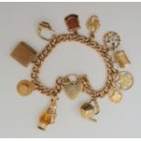 A 9ct gold charm bracelet hallmarked to every link, clasp and seven of the attached charms one is