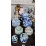 A lot comprising a selection of blue and white ginger jars, a celadon example, A Satsuma egg &