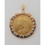 A Victorian shield back half gold sovereign in yellow, red and white 9ct gold pendant mount,