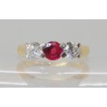 An 18ct gold ruby and diamond three stone ring, set with two estimated approx 0.30ct of brilliant