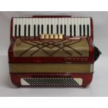 A Hohner Virtuola III accordion in black, 41 keys and 120 bass buttons together with a soft carry