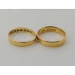 An 18ct gold wedding ring size M, and a thinner example size L1/2, weight combined 4.4gms