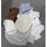 A lot comprising an assortment of knitted shawls & blankets, a black lace shawl, a white nylon scarf