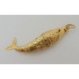 An Italian made articulated fish pendant with red gem eyes, length 5cm, weight 2.3gms Condition