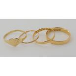 An 18ct gold wedding ring size T, a thinner example size O1/2, weight 4.1gms, and two yellow metal