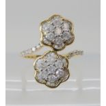 a 9ct gold double diamond flower ring, set with brilliant and baguette cut diamonds, size M1/2,