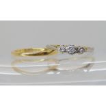 An 18ct gold wedding ring size K, together with a 18ct gold illusion set three stone diamond ring