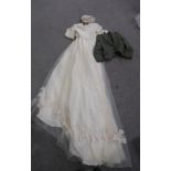 A lot comprising an ivory and applied lace wedding dress with hat, a child's green tweed jacket