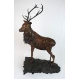 BRUCE WEIR - THE STAG a bronze sculpture, modelled standing on a sloping naturalistic base, together