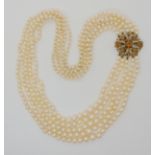 A FIVE STRAND PEARL NECKLACE WITH A 9CT CITRINE AND PEARL CLASP the strings are graduated to be worn