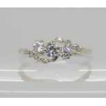 AN 18CT WHITE GOLD AND PLATINUM THREE STONE DIAMOND RING the diamonds combined are estimated