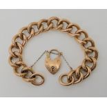 A 9CT ROSE GOLD CURB LINK BRACELET WITH ENGRAVED DETAIL stamped 9c to every link and the clasp, each