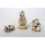 A JAPANESE IVORY NETSUKE carved with a child seated on a turtle man, signed, 4cm high, carving of