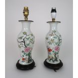 A PAIR OF CHINESE BALUSTER VASES painted with two boys playing beside flowers and foliage, fixed