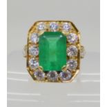 AN 18CT GOLD EMERALD AND DIAMOND DRESS RING the emeralds dimensions are 13.1mm x 9.2mm x 5.9mm, both