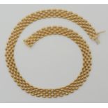 A 9CT GOLD FANCY LINK CHAIN with British import marks for Sheffield 1991, length 43.4cm, 1.1cm wide,