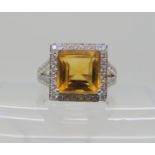 A PLATINUM DIAMOND AND CITRINE DRESS RING set with a square cut citrine dimensions 10mm x 10mm x