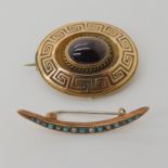 TWO VINTAGE BROOCHES an oval brooch with glazed locket back, set with a garnet and a Greek Key