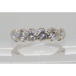 AN 18CT WHITE GOLD SIX STONE DIAMOND RING set with two 0.20cts and four 0.30cts brilliant cut