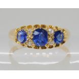A SAPPHIRE AND DIAMOND THREE STONE RING the largest sapphire measures approx 5mm x 4mm x 2.9mm,