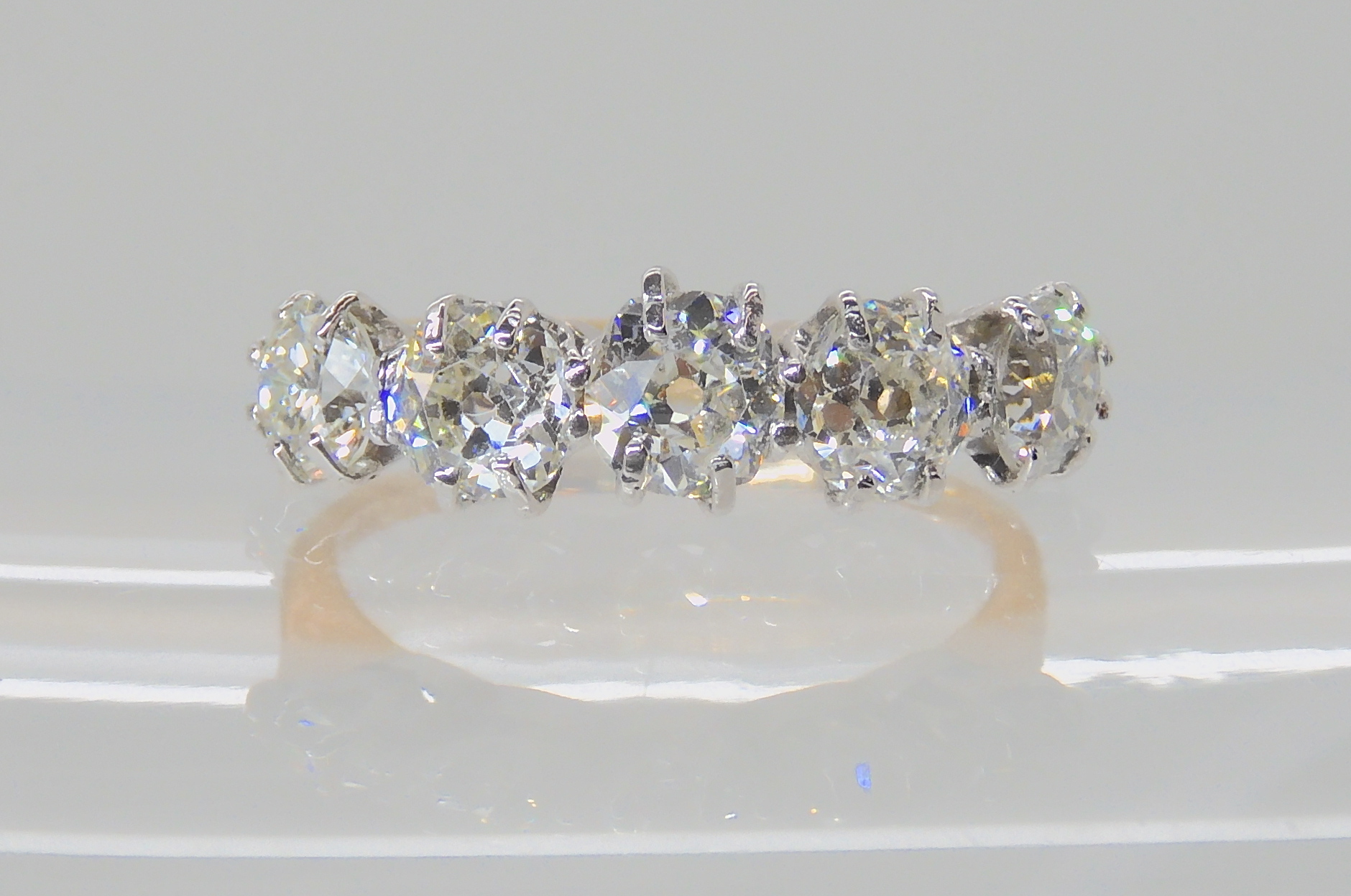 A FIVE STONE DIAMOND RING set with five old cut diamonds to an estimated approx combined total of