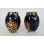 A PAIR OF CARLTON WARE FANTASIA PATTERN VASES the dark blue ground with coloured enamel and gilt