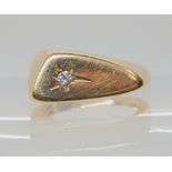 A 14K GOLD SCANDINAVIAN RETRO STYLE RING the smooth sculptural shape set with a 0.05ct diamond,