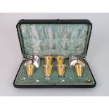 A ROYAL DOULTON SILVER MOUNTED COFFEE SET the yellow glazed cups with pierced Art Nouveau style