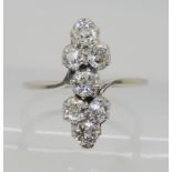 AN ART DECO SEVEN STONE CLUSTER RING the seven old cut diamonds are claw set in an elegant