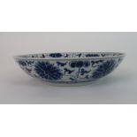A CHINESE BLUE AND WHITE DISH painted with peonies and scrolling foliage, bears Guangxu mark, 20cm