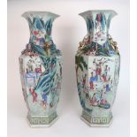 A LARGE PAIR OF CANTON FAMILLE ROSE HEXAGONAL VASES each painted with mandarins on terraces