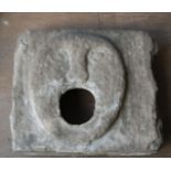 A 16th/17th century STONE CARVED FOUNTAIN HEAD the square panel carved with an oval flattened
