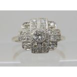A VINTAGE DIAMOND CLUSTER RING mounted in 18ct white gold and platinum, and set with estimated