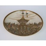 A SATSUMA DISH painted in fine detail with a pagoda and numerous figures, in colours and gilts,
