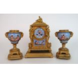 A FRENCH ORMOLU AND PORCELAIN CLOCK AND GARNITURE the dial painted with a cherub, Roman numerals and